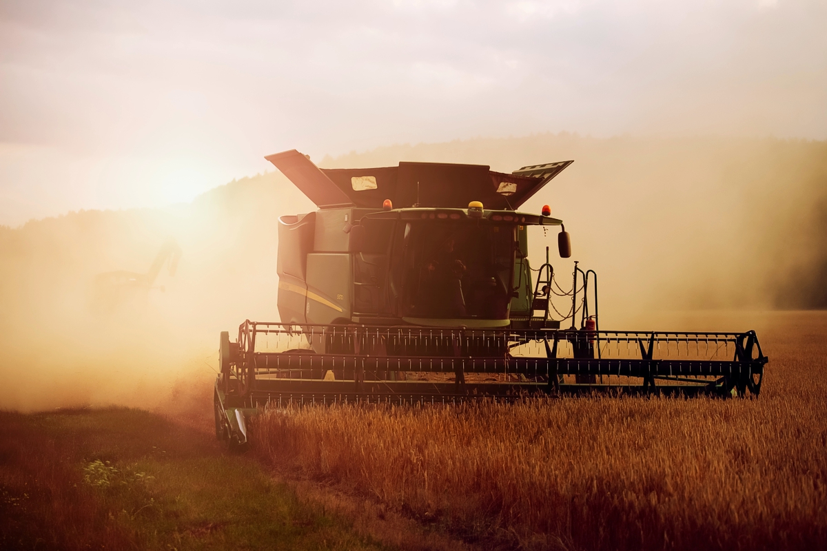 Atmospheric photo of a harvester in setting sunlight