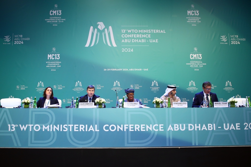 Photo of the podium of the press conference by participants in the services domestic regulation deal at the Abu Dhabi Ministerial Conference, February 27, 2024