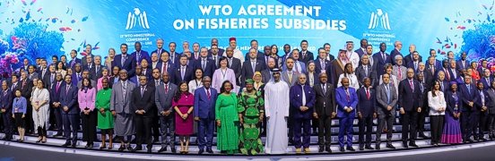 Thumbnail photo of representatives of 69 countries that had ratified the 2022 Fisheries Subsidies Agreement on stage at the Abu Dhabi Ministerial Conference