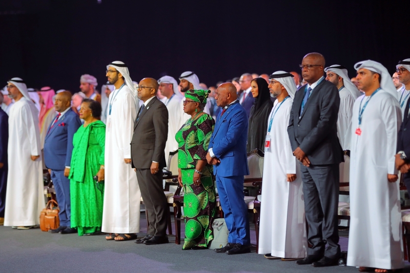 VIPs in the front row as delegates stand in the opening ceremony, WTO Abu Dhabi Ministerial Conference